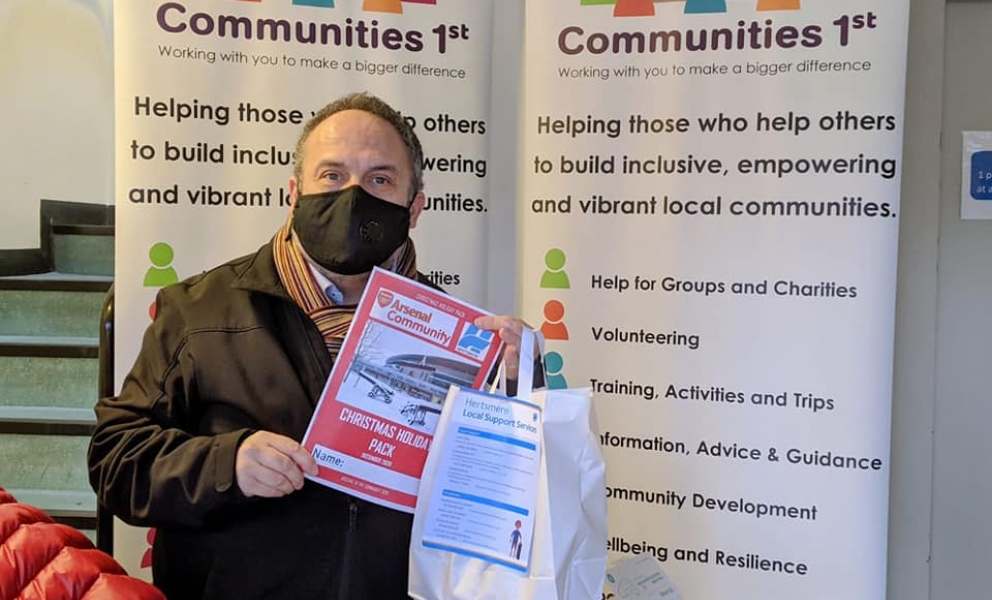 Leader of the Council, Cllr Morris Bright MBE, with the Arsenal Christmas holiday pack included in the parcel