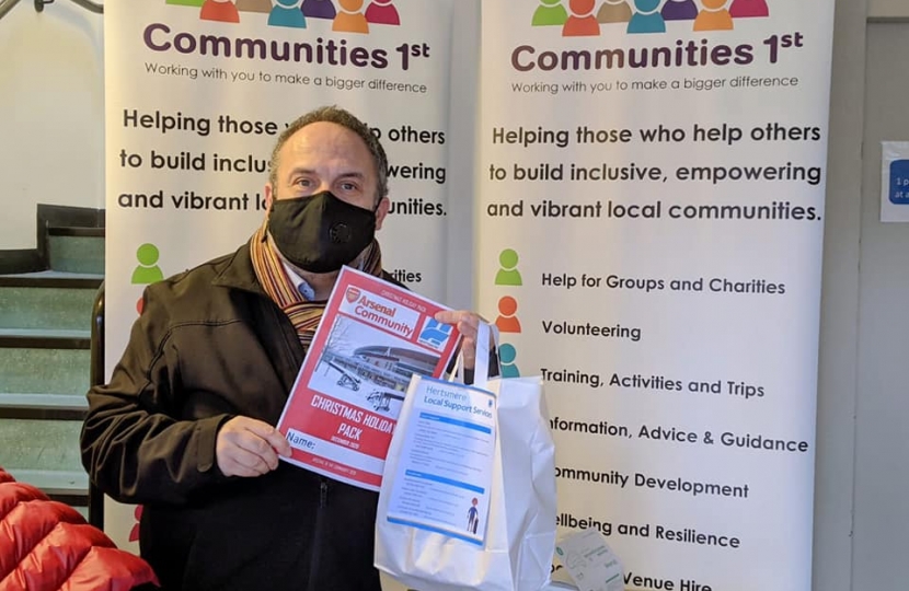 Leader of the Council, Cllr Morris Bright MBE, with the Arsenal Christmas holiday pack included in the parcel